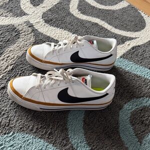 Nike Womens White Sneakers with Black Swoosh and Gold Trim